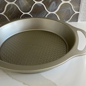 Nordic Ware pie plate or baking dish with handles.  Gold color.  New